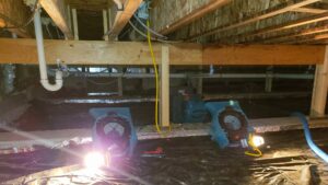 Technician using industrial pump to extract water from flooded basement vancouver