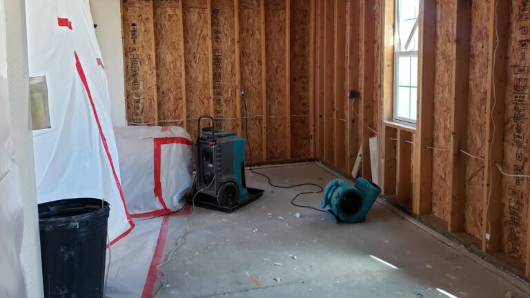 Industrial dehumidifiers and air movers drying the floor of a warehouse after water damage vancouver bc
