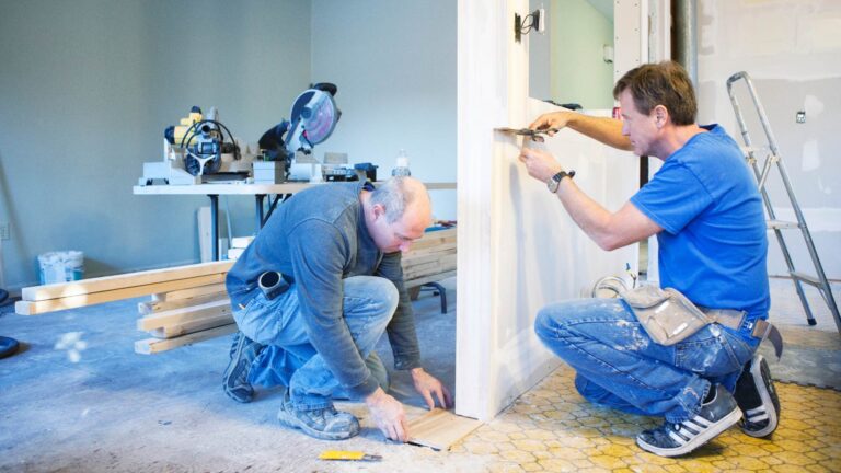 Carpenter performing repair and renovation work installing custom kitchen cabinets in Vancouver