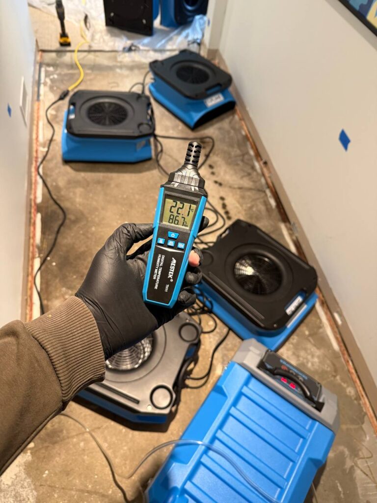 Water damage restoration technicians drying a flooded basement in Vancouver