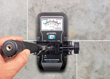 Professional moisture meter checking moisture levels in building materials